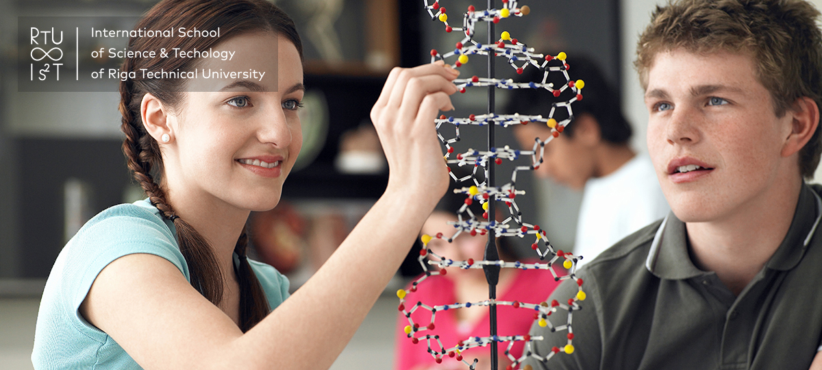 Image of happy teenage students examining DNA model and taking notes in science class.